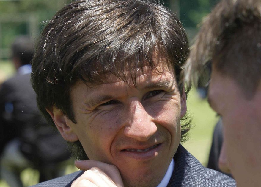 FILE - In this Friday, Dec. 4, 2009 file photo, Russia 2018 delegate, soccer player, Alexei Smertin attends an expo for countries bidding to host the 2018 World Cup in Cape Town, South Africa. Former Chelsea midfielder Smertin has been put in charge of investigating soccer racism in Russia, despite previously appearing to deny it existed. (AP Photo/Victor R. Caivano, File)