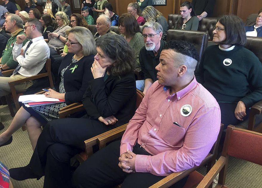 Kenzo Morris, right, listens during a public hearing on a bill that would bar discrimination based on gender identity, Tuesday, Feb. 21, 2017, in Concord, N.H. Morris, a stay-at-home father, came out as transgender four years ago. Morris testified that he was mocked when he went to change the gender identity on his driver's license. (AP Photo/Kathleen Ronayne)
