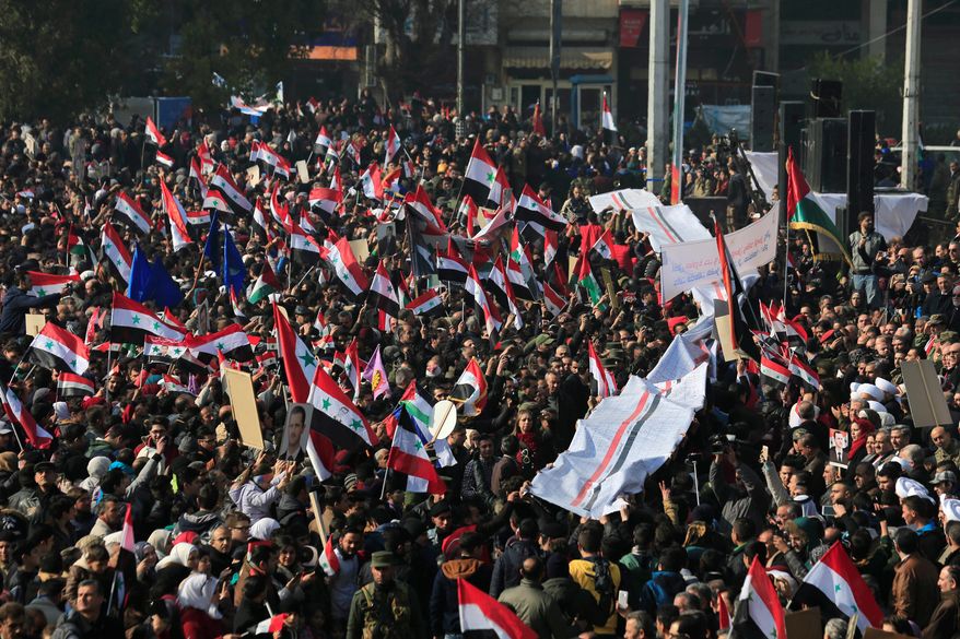 Supporters of Syrian President Bashar Assad celebrated a government military victory in Aleppo last month. A common enemy, the Islamic State terrorist group, has created a delicate coalition of U.S., Turkish, Russian and Iranian-backed forces, as well as moderate Sunni Muslim Arab rebels and Kurdish paramilitaries. (Associated Press)