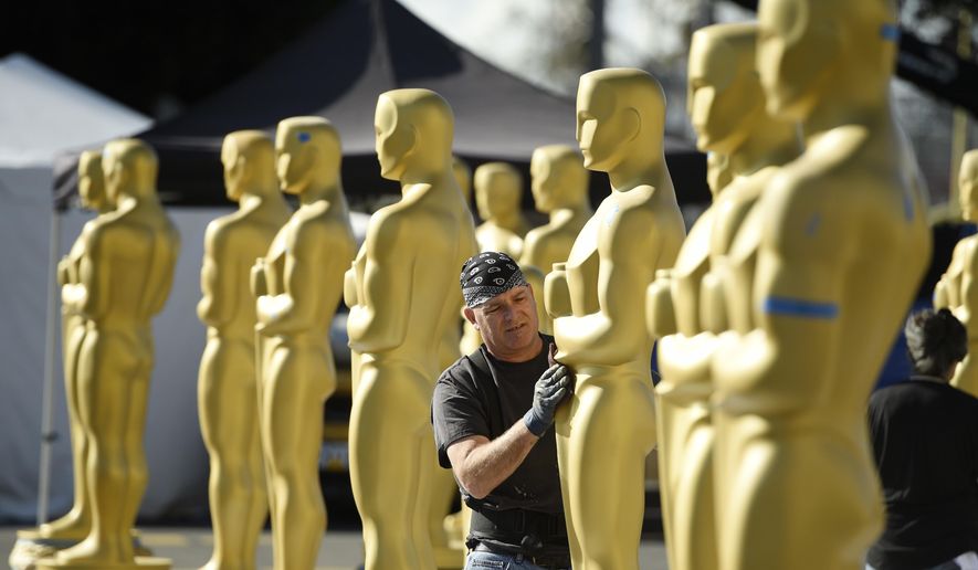 Scenic artist Rick Roberts of Local 800 primps Oscar statues near the Dolby Theatre on Wednesday, Feb. 22, 2017, in Los Angeles. The 89th Academy Awards will be held on Sunday. (Photo by Chris Pizzello/Invision/AP)