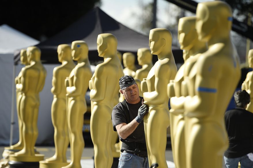 Scenic artist Rick Roberts of Local 800 primps Oscar statues near the Dolby Theatre on Wednesday, Feb. 22, 2017, in Los Angeles. The 89th Academy Awards will be held on Sunday. (Photo by Chris Pizzello/Invision/AP)