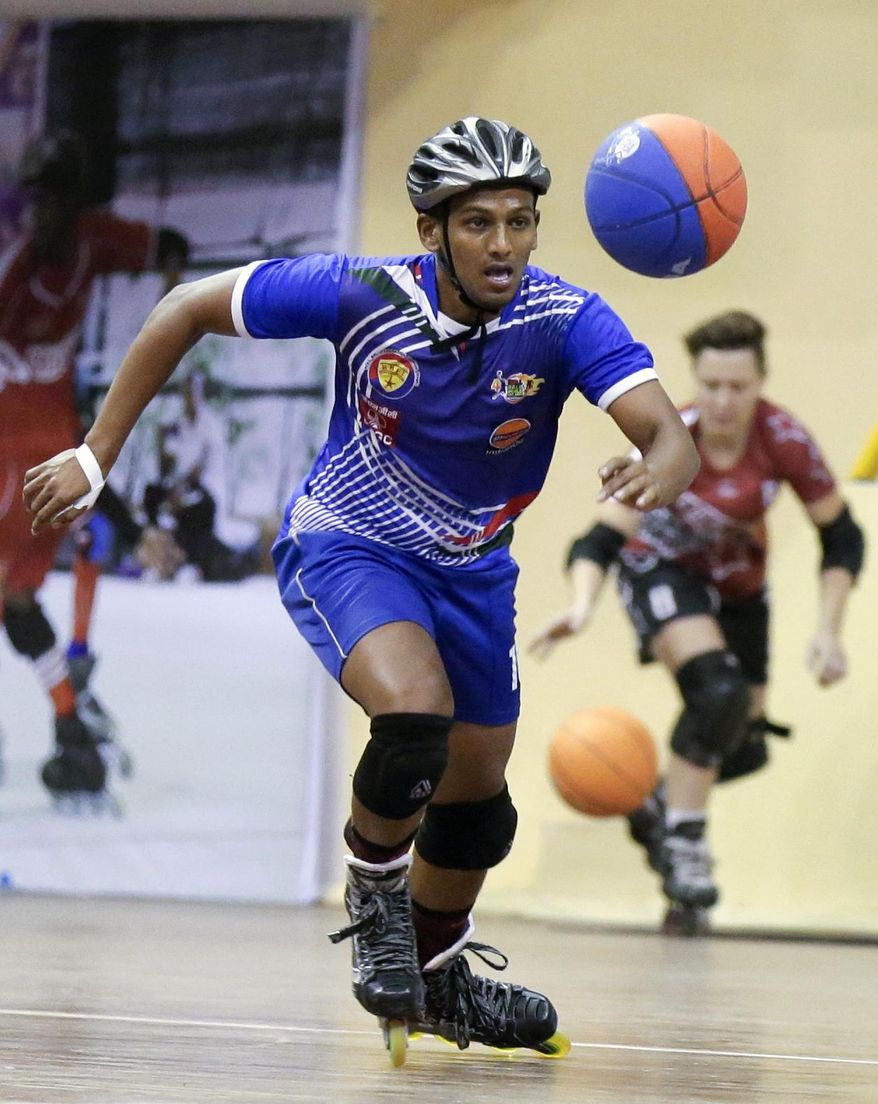 In this Tuesday, Feb. 21, 2017 photo, Chandran Sharma of India skates to the ball during the 4th Roll Ball World Cup quarterfinal match against Zambia at Shaheed Sohrawardi Indoor Stadium in Dhaka, Bangladesh. Bangladesh hosted the championship for an unusual sport, roll ball, where players on roller skates dribble and pass a basketball-sized ball that they try to throw into a small soccer-type goal. About 750 players from 40 countries around the world took part. Top honors, both for men and women, went to India, where the sport was invented. (AP Photo/A.M. Ahad)