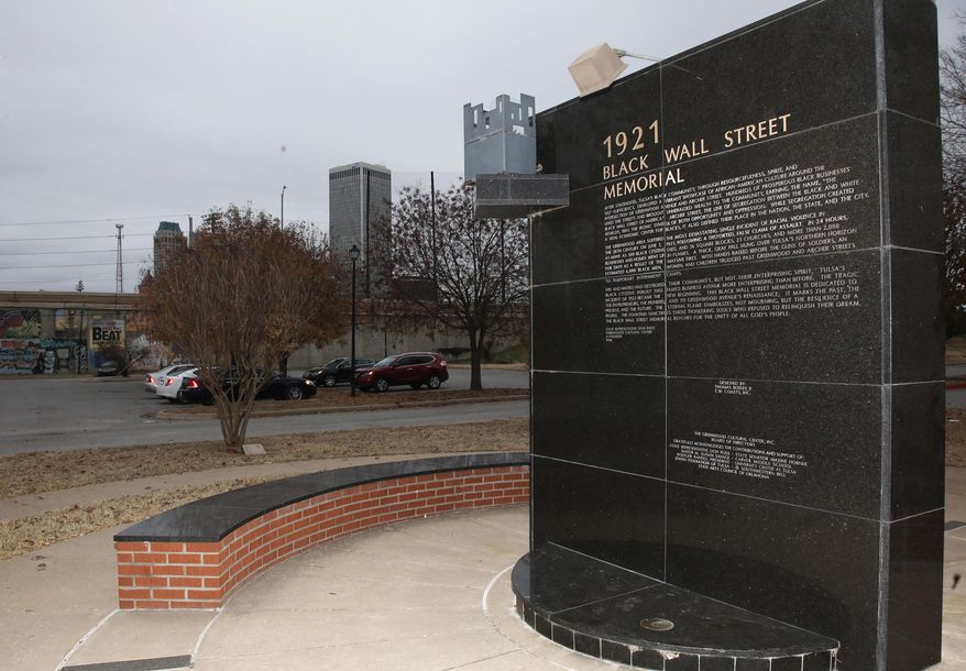 In this Thursday, Dec. 15, 2016 photo, a memorial to Tulsa&#39;s Black Wall Street sits outside the Greenwood Cultural Center on the outskirts of downtown Tulsa, Okla. A once-prosperous section of Tulsa that became the site of one of the worst race riots in American history is attempting to remake itself again after decades of neglect. Black leaders want to bring 100 new companies to the former Black Wall Street in north Tulsa by 2021, the 100th anniversary of its fall. (AP Photo/Sue Ogrocki)