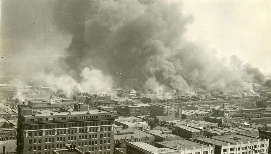 In this undated photo provided by Tulsa Historical Society and Museum, Greenwood neighborhood also known as Black Wall Street in Tulsa, Okla., is burned down during a race riot in 1921. The once-prosperous section of Tulsa that became the site of one of the worst race riots in American history is attempting to remake itself again after decades of neglect. Black leaders want to bring 100 new companies to the former Black Wall Street in north Tulsa by 2021, the 100th anniversary of its fall. (Courtesy of Tulsa Historical Society &amp;amp; Museum via AP)