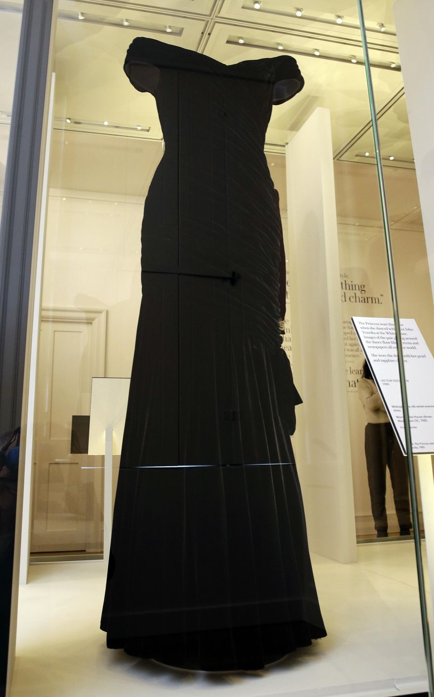 A Victor Edelstein dress in midnight blue silk velvet, worn by Diana Princess of Wales at a State Dinner at the White House in 1985, on display during a media preview of an exhibition of 25 dresses and outfits worn by Diana, Princess of Wales entitled "Diana: Her Fashion Story" at Kensington Palace in London, Wednesday, Feb. 22, 2017. (AP Photo/Alastair Grant)
