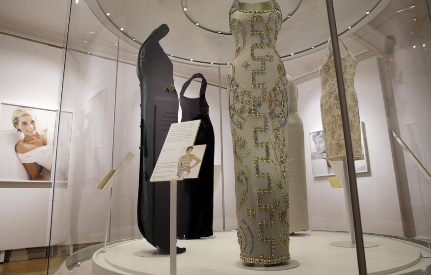 A Versace ice blue silk gown with beading, centre, worn by Diana, Princess of Wales in 1991 for a Bazaar magazine shoot with photographer Partick Demarchelier, is on display during a media preview of an exhibition of 25 dresses and outfits worn by Diana entitled "Diana: Her Fashion Story" at Kensington Palace in London, Wednesday, Feb. 22, 2017. (AP Photo/Alastair Grant)