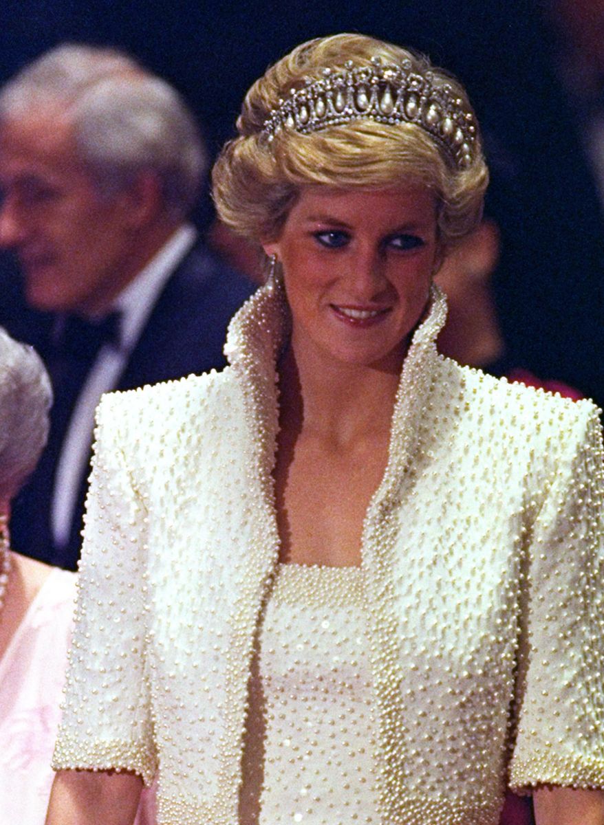 FILE - In this 1989 file photo, Diana, Princess of Wales smiles during an official visit to Hong Kong. This dress is part of an exhibition of 25 dresses and outfits worn by Diana entitled "Diana: Her Fashion Story" at Kensington Palace in London, opening on Friday, Feb. 24, 2017. (AP Photo/Liu Heung Shing, file)