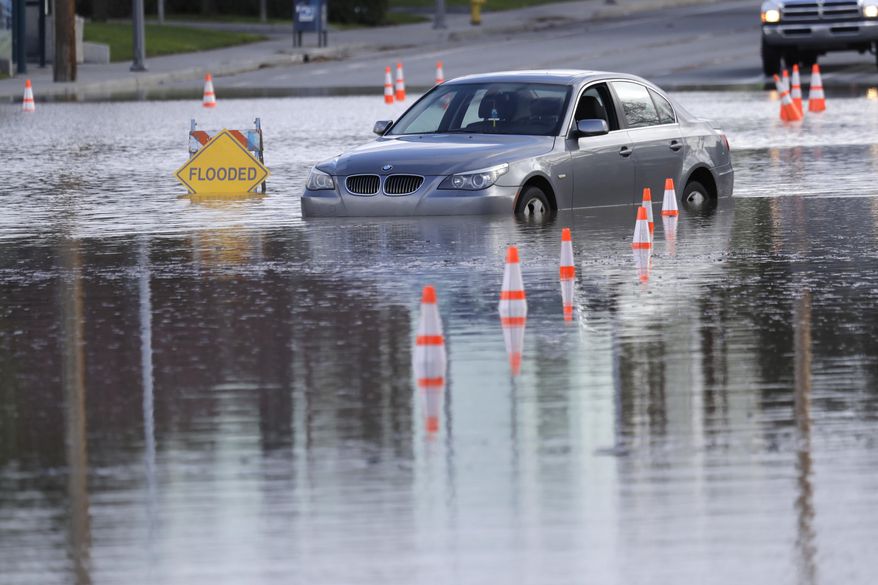 A car is submerged on a flooded road Tuesday, Feb. 21, 2017, in San Jose, Calif. Rains have saturated once-drought stricken California but have created chaos for residents hit hard by the storms. The latest downpours swelled waterways to flood levels and left about half the state under flood, wind and snow advisories. (AP Photo/Marcio Jose Sanchez)