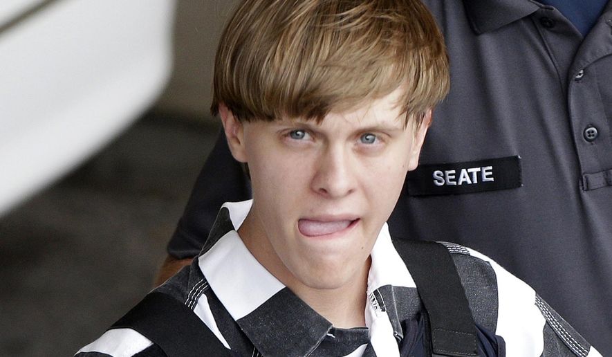 FILE - In this June 18, 2015 file photo, Charleston, S.C., shooting suspect Dylann Storm Roof is escorted from the Cleveland County Courthouse in Shelby, N.C.  In court documents unsealed Tuesday, Feb. 21, 2017, Roof, convicted of killing nine worshippers during Bible study at a black church drove toward a second black church after the shootings, according to South Carolina prosecutors who oversaw the federal case against him.  (AP Photo/Chuck Burton, File)