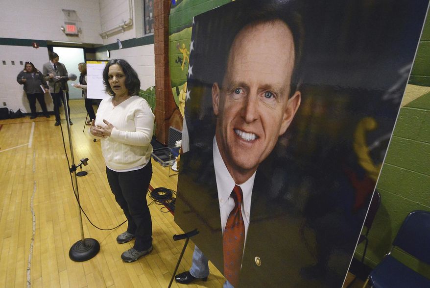 Anna Washick, of Thornhurst, Pa., tells her story regarding health care next to a large photograph of Sen. Pat Toomey, R-Pa., at the United Neighborhood Center in Scranton, Pa., Tuesday, Feb. 21, 2017. Toomey was invited to speak at the town hall, but did not attend. (Butch Comegys/The Times & Tribune via AP)