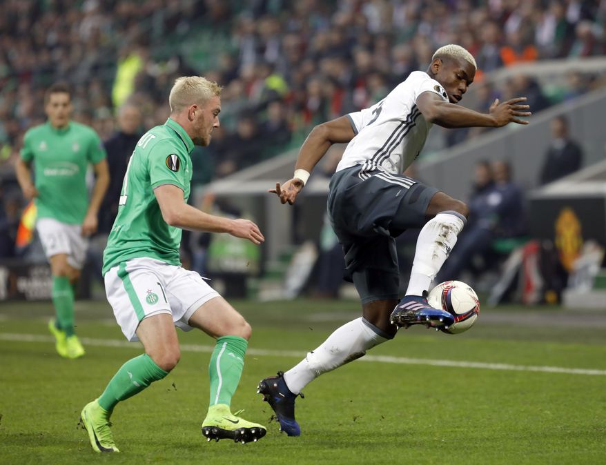 Manchester United's Paul Pogba, right, controls the ball while Saint Etienne's Jordan Veretout looks on during a Europa League round of 32 second leg soccer match between Saint Etienne and Manchester United at Geoffroy-Guichard stadium in Saint Etienne, France, Wednesday, Feb. 22, 2017. (AP Photo/Laurent Cipriani)