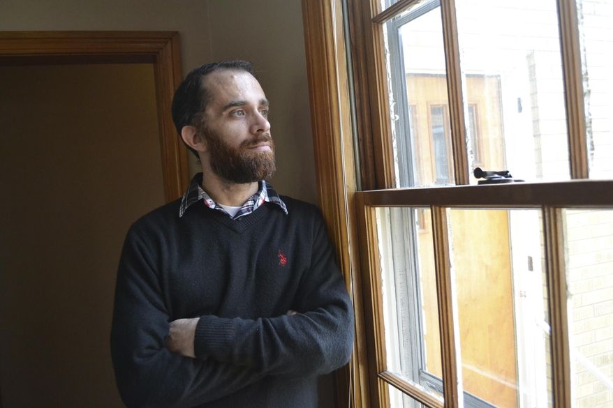 In a Wednesday, Feb. 1, 2017 photo, Tyler Witten peers through a window at the Sanibel House, a residential addiction center in Catlettsburg, Ky. Witten, a former opioid addict, has gone through an addiction program and now works as a weekend staffer at the house. The house and other centers are operated by Addiction Recovery Care, which is seeing many new patients who are covered under Kentuckys Medicaid expansion as part of the Affordable Care Act. (AP Photo/Dylan Lovan)