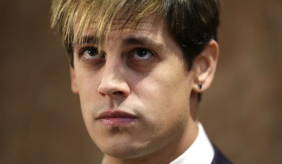 Milo Yiannopoulos listens during a news conference in New York, Tuesday, Feb. 21, 2017. Yiannopoulos has resigned as editor of Breitbart Tech after coming under fire from other conservatives over comments on sexual relationships between boys and older men. (AP Photo/Seth Wenig)