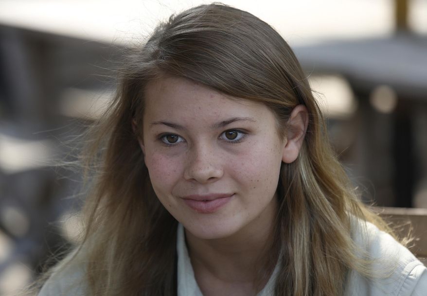 FILE - In this Thursday, Oct. 24, 2013 file photo, Bindi Irwin, Australian-based animal activist and television personality, listens to reporter's questions during an interview in Hong Kong. Irwin paid tribute with a post about her father, the late "Crocodile Hunter" Steve Irwin, on what would have been his 55th birthday on Feb. 22, 2017. (AP Photo/Vincent Yu, File)