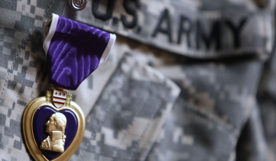 FILE- An Aug. 7, 2007, file photo, the Purple Heart medal is worn by Army PFC Marcus D. LaBadie, 21, of Jamestown, N.Y., during a ceremony at Walter Reed Army Medical Center in Washington. Democratic U.S. Rep. Sean Patrick Maloney says he will join other officials Wednesday, Feb. 22, 2017, at the National Purple Heart Hall of Honor in New Windsor, N.Y., to announce federal legislation to honor the museum with a commemorative coin. The hall is dedicated to the more than 1.7 million service members who have been awarded the Purple Heart. (AP Photo/Charles Dharapak, File)