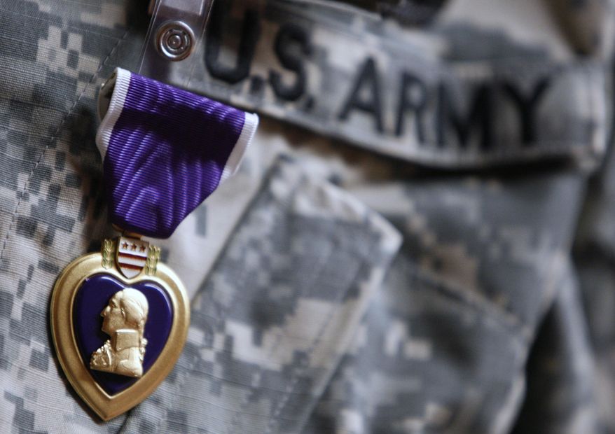 FILE- An Aug. 7, 2007, file photo, the Purple Heart medal is worn by Army PFC Marcus D. LaBadie, 21, of Jamestown, N.Y., during a ceremony at Walter Reed Army Medical Center in Washington. Democratic U.S. Rep. Sean Patrick Maloney says he will join other officials Wednesday, Feb. 22, 2017, at the National Purple Heart Hall of Honor in New Windsor, N.Y., to announce federal legislation to honor the museum with a commemorative coin. The hall is dedicated to the more than 1.7 million service members who have been awarded the Purple Heart. (AP Photo/Charles Dharapak, File)