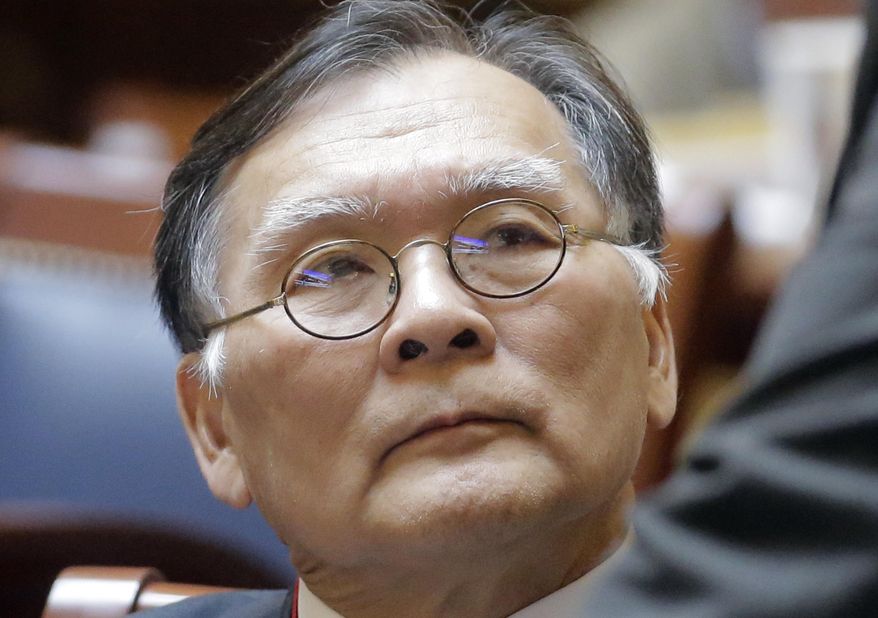 Republican Sen. Brian Shiozawa sits on the Senate floor at the Utah State Capitol Wednesday, Feb. 22, 2017, in Salt Lake City. A resolution expressing Utah's commitment to protecting the rights of legal immigrants and refugees fleeing persecution has received full support from a panel of lawmakers. Bill sponsor Shiozawa says his grandfather moved to the U.S. from Japan as a single man who didn't speak any English. (AP Photo/Rick Bowmer)
