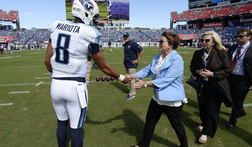 FILE -- In this Sept. 11, 2016 file photo, Tennessee Titans quarterback Marcus Mariota (8) greets Titans owner Amy Adams Strunk, center, before an NFL football game against the Minnesota Vikings in Nashville, Tenn. A year ago, Strunk could only promise hope to Tennessee season-ticket holders. Now the general manager and coach she hired went 9-7 in their first season and lots of ammunition to build with as they meet with season-ticket holders Wednesday night. (AP Photo/Mark Zaleski, File)