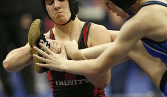 In this Feb. 18, 2017 photo, Euless Trinity&#39;s Mack Beggs, left, wrestles Grand Prairie&#39;s Kailyn Clay during the finals of the UIL Region 2-6A wrestling tournament at Allen High School in Allen, Texas.   Beggs, who is transgender, is transitioning from female to male, won the girls regional championship after a female opponent forfeited the match. (Nathan Hunsinger/The Dallas Morning News via AP)