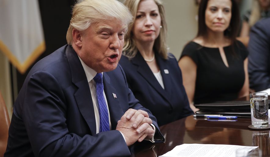 President Donald Trump speaks during a meeting on domestic and international human trafficking, Thursday, Feb. 23, 2017, in the Roosevelt Room of the White House in Washington. With Trump are Michelle DeLaune, center, National Center for Missing and Exploited Children, and Dina Powell, right, White House Senior Counselor for Economic Initiatives. (AP Photo/Pablo Martinez Monsivais)