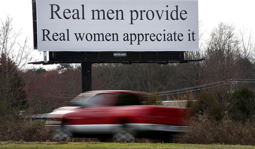 A vehicle drives by a billboard, Wednesday, Feb. 22, 2017, near Greensboro, N.C. The billboard on a highway between Winston-Salem and Greensboro reads, "Real men provide. Real women appreciate it." Women are planning this weekend to protest a North Carolina billboard with a message they say is a slam on gender equality, according to media reports. (Andrew Krech/News & Record via AP)/
