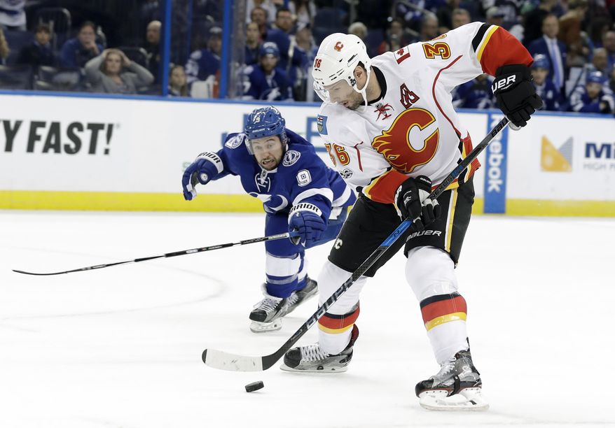 Calgary Flames right wing Troy Brouwer (36) gets around Tampa Bay Lightning center Tyler Johnson during the first period of an NHL hockey game Thursday, Feb. 23, 2017, in Tampa, Fla. (AP Photo/Chris O&#x27;Meara)