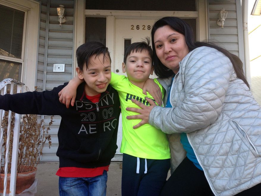 Gabriela Baraja, right, and her sons Melvin Garcia, left, and Antonio Garcia pose for a photo at their home in Chicago on Wednesday, Feb. 22, 2017. As President Donald Trump moves ahead with a nationwide immigration crackdown, school principals in Chicago have been given a simple order: Do not let federal immigration agents in without a criminal warrant. Barajas was brought to the U.S. illegally as a child but is allowed to stay as part of a federal program launched in 2012. (AP Photo/Don Babwin)