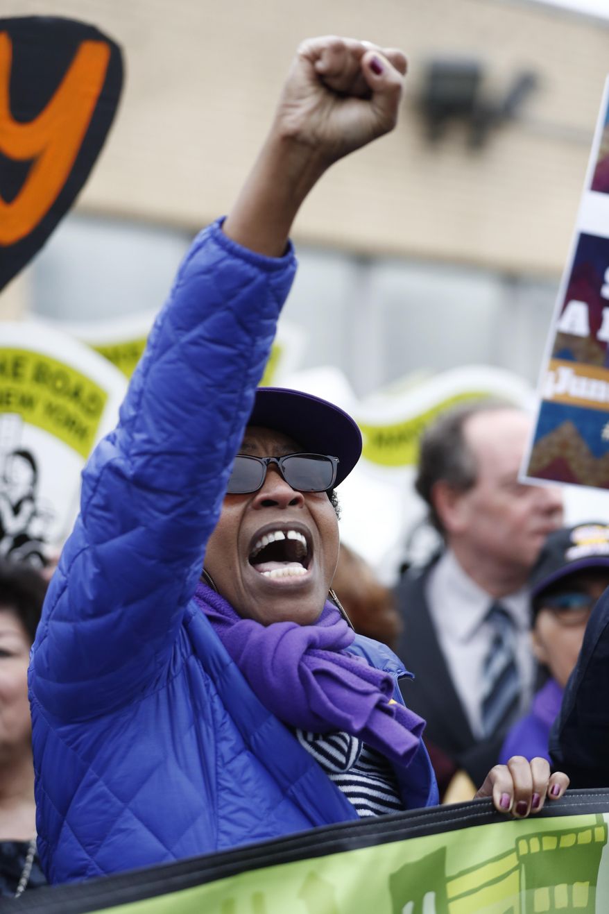 A woman chants during an immigration protest outside of a detention center, Thursday, Feb. 23, 2017, in Elizabeth, N.J. More than 100 protesters lined the street outside of the detention center. They chanted against recent raids by federal immigration authorities and against President Donald Trump's proposed wall on the Mexican border. (AP Photo/Julio Cortez)