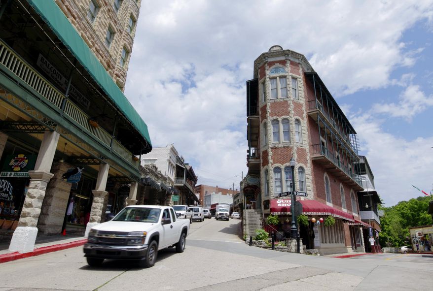 FILE - In this May 6, 2015, file photo, traffic passes through downtown Eureka Springs, Ark. The Arkansas Supreme Court ruled Thursday, Feb. 23, 2017, that a Fayetteville ordinance extending anti-discrimination protection to members of the LGBT community violated a state law. Fayetteville, Eureka Springs and a handful of other cities had approved local ordinances prohibiting discrimination. The court agreed with state lawyers who said legislators intended to have uniform anti-discrimination measures statewide. (AP Photo/Danny Johnston, File)