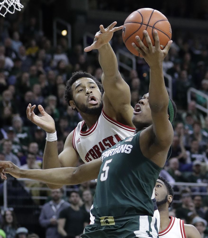 Michigan State guard Cassius Winston (5) makes a layup while defended by Nebraska forward Ed Morrow (30) during the second half of an NCAA college basketball game, Thursday, Feb. 23, 2017, in East Lansing, Mich. (AP Photo/Carlos Osorio)