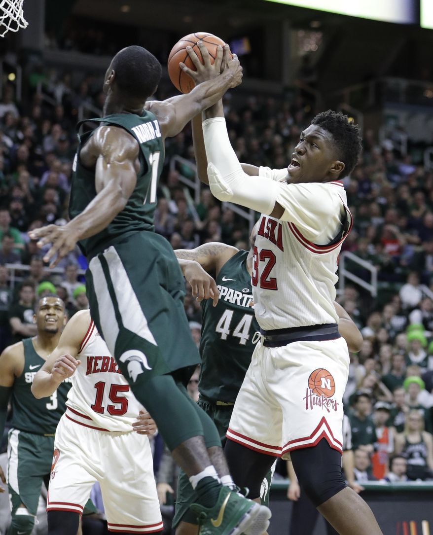 Michigan State guard Lourawls Nairn Jr. (11) reaches in to block a shot by Nebraska center Jordy Tshimanga (32) during the first half of an NCAA college basketball game, Thursday, Feb. 23, 2017, in East Lansing, Mich. (AP Photo/Carlos Osorio)