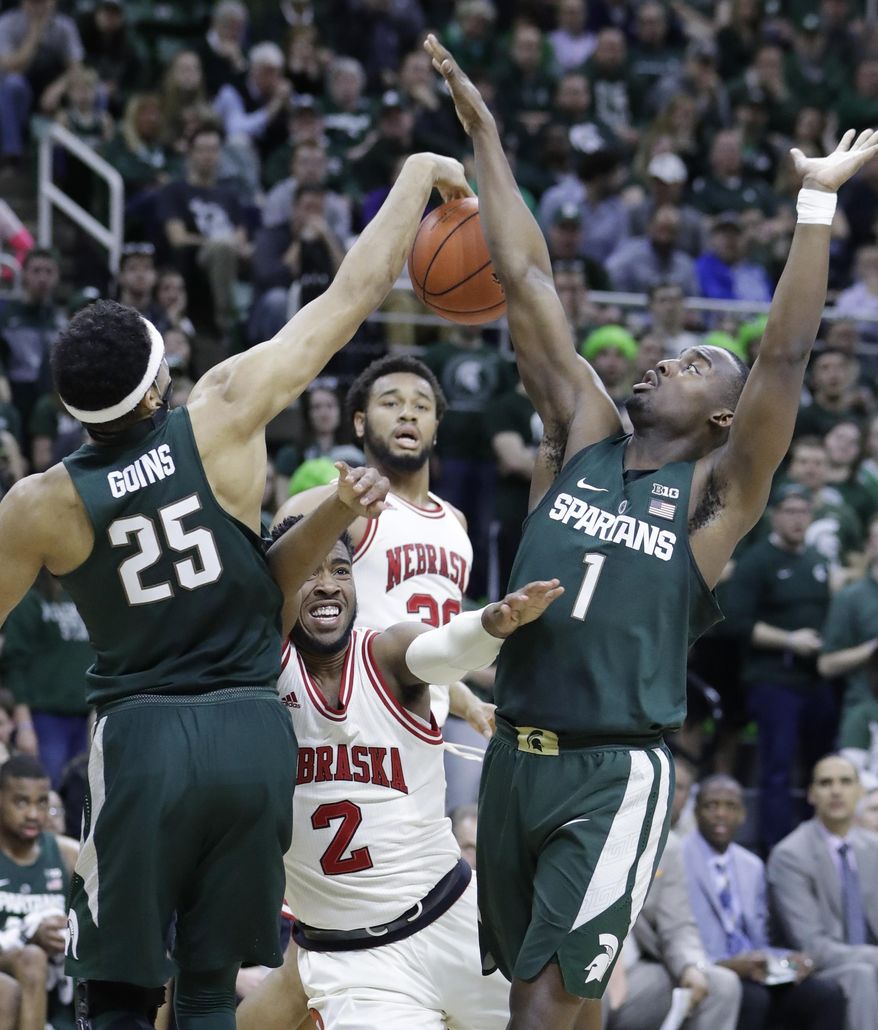 Michigan State forward Kenny Goins (25) swats the ball away from Nebraska forward Jeriah Horne (2) during the first half of an NCAA college basketball game, Thursday, Feb. 23, 2017, in East Lansing, Mich. (AP Photo/Carlos Osorio)