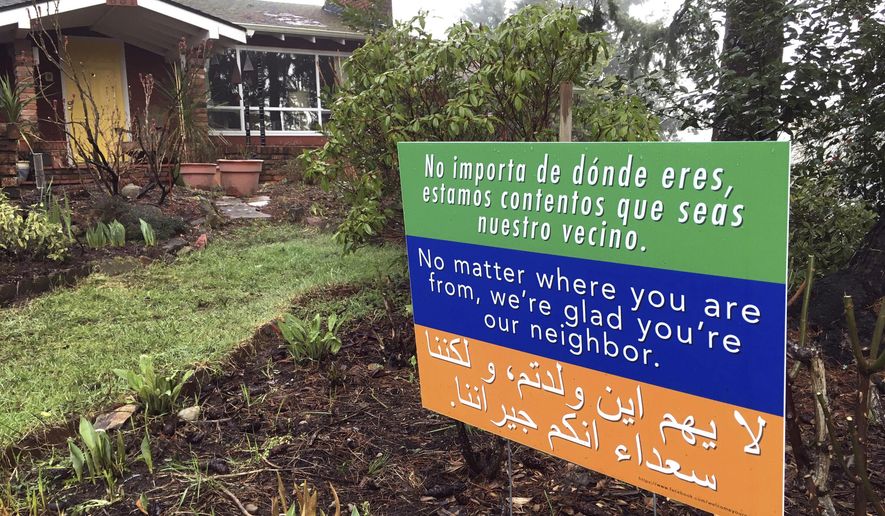 A welcome sign in three languages is displayed in a yard in Salem, Ore., Thursday, Feb. 23, 2017. Emphasizing ways in which Oregon is reliant on immigrants, the state has told a federal court it wants to join Washington state&#x27;s lawsuit against President Donald Trump&#x27;s immigration ban. (AP Photo/Andrew Selsky)