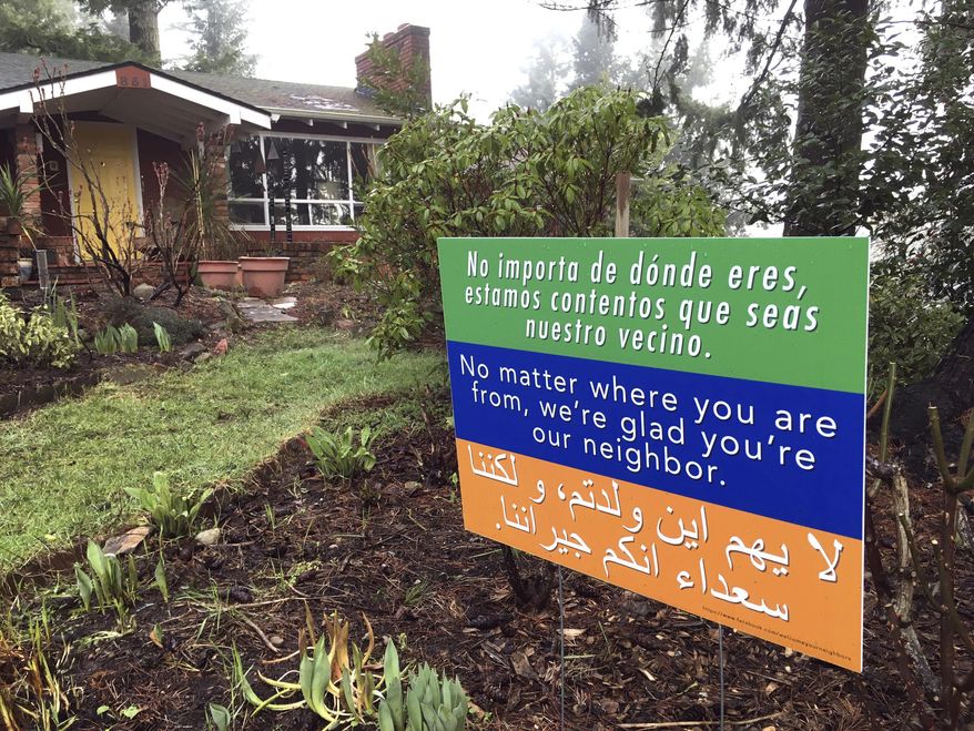 A welcome sign in three languages is displayed in a yard in Salem, Ore., Thursday, Feb. 23, 2017. Emphasizing ways in which Oregon is reliant on immigrants, the state has told a federal court it wants to join Washington state's lawsuit against President Donald Trump's immigration ban. (AP Photo/Andrew Selsky)