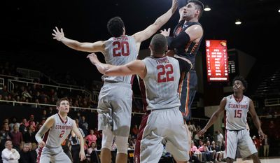 Oregon State center Gligorije Rakocevic, top center, shoots over Stanford center Josh Sharma (20) and forward Reid Travis (22) during the first half of an NCAA college basketball game Wednesday, Feb. 22, 2017, in Stanford, Calif. (AP Photo/Marcio Jose Sanchez)