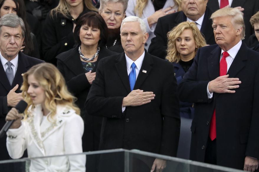 FILE - In this Jan. 20, 2017, file photo, Vice President Mike Pence and President Donald Trump listen to the singing of the national anthem by Jackie Evancho during the 58th Presidential Inauguration at the U.S. Capitol in Washington. Evancho asked Trump in a tweet on Feb. 22, 2017, to meet with her and her transgender sister on transgender rights. (AP Photo/Andrew Harnik, File)