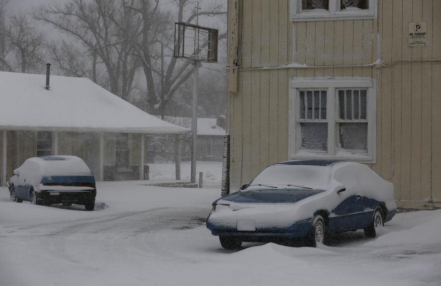 Snow drifts against cars parked outside Walnut Street apartments during a winter storm Thursday, Feb. 23, 2017 in Casper, Wyoming. (Alan Rogers /The Casper Star-Tribune via AP)