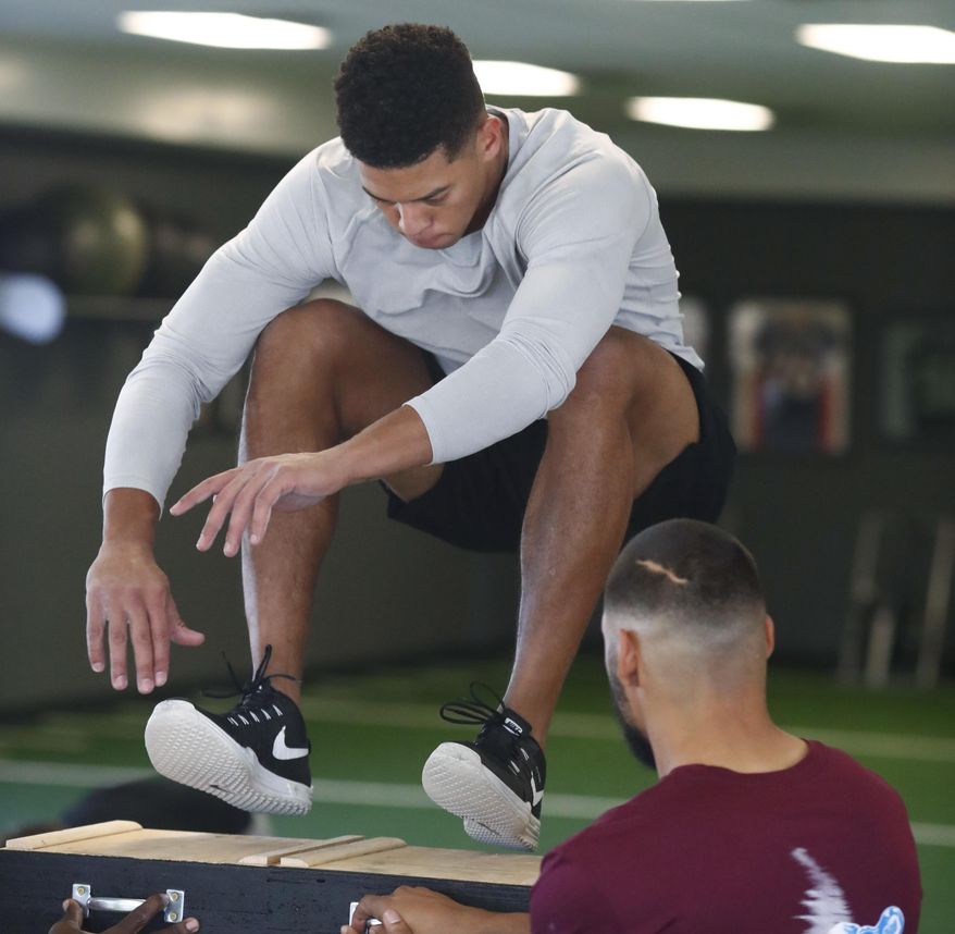 In this Thursday, Feb. 16, 2017, photograph, Air Force wide receiver Jalen Robinette takes part in a drill to prepare for the NFL Combine at a workout facility in Centennial, Colo. Robinette is taking six courses at the academy as he prepares for dual careers as an Air Force officer and an NFL wide receiver. (AP Photo/David Zalubowski)
