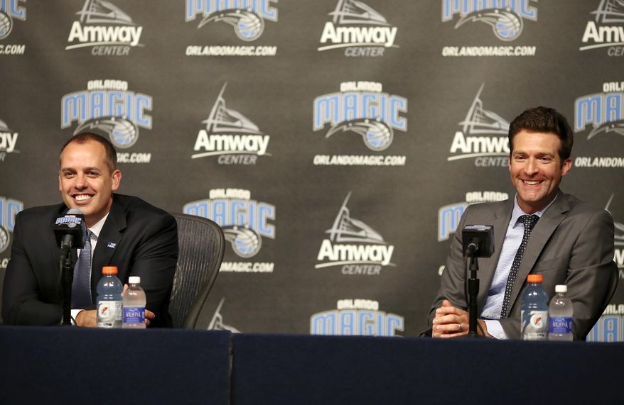 FILE - In this May 23, 2016, file photo, Orlando Magic general manager Rob Hennigan, right, and head coach Frank Vogel address the media in Orlando. Magic president Alex Martins is pleased with Orlando's young core of players and coach Frank Vogel, but is disappointed the team probably won't get to the playoffs for the first time in the post-Dwight Howard era. Martins says the future of the management team, including 34-year-old general manager Rob Hennigan, will be evaluated after the season. (Jacob Langston/Orlando Sentinel via AP, File)