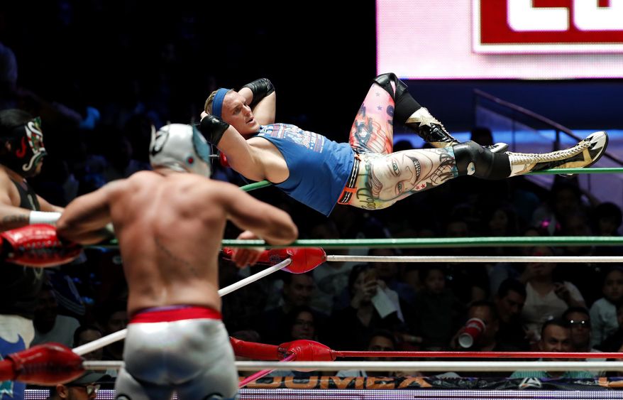 ADVANCE FOR USE SATURDAY, FEB. 25, AND THEREAFTER – FILE – In this Feb. 12, 2017, file photo, American pro wrestler Sam Polinsky, who works under the name "Sam Adonis" while adopting the ring persona of a flamboyant supporter of U.S. President Donald Trump, balances on the corner ropes during a bout at Arena Mexico in Mexico City. Polinsky, who grew up about 10 miles east of Pittsburgh in Monroeville, Pa., wrestles in Mexico's Consejo Mundial de Lucha Libre. Pro wrestling has often tapped into a good-vs.-evil mentality, and Polinsky's "Sam Adonis" persona riles wrestling fans in a country the president has pledged will pay for a border wall. (AP Photo/Eduardo Verdugo, File)