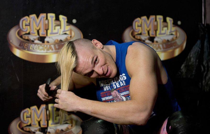 ADVANCE FOR USE SATURDAY, FEB. 25, AND THEREAFTER – FILE – In this Feb. 12, 2017, file photo, American pro wrestler Sam Polinsky, who works under the name "Sam Adonis" while adopting the ring persona of a flamboyant supporter of U.S. President Donald Trump, straightens his hair as he prepares for a bout at Arena Mexico in Mexico City. Polinsky, who grew up about 10 miles east of Pittsburgh in Monroeville, Pa., wrestles in Mexico's Consejo Mundial de Lucha Libre. Pro wrestling has often tapped into a good-vs.-evil mentality, and Polinsky's "Sam Adonis" persona riles wrestling fans in a country the president has pledged will pay for a border wall. (AP Photo/Eduardo Verdugo, File)