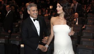 Actor George Clooney and Amal Clooney arrive at the 42nd Cesar Film Awards ceremony at Salle Pleyel in Paris, Friday, Feb. 24, 2017. This annual ceremony is presented by the French Academy of Cinema Arts and Techniques. (AP Photo/Thibault Camus)