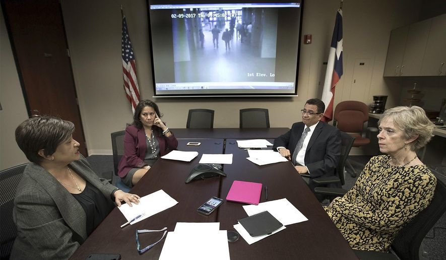 In this Thursday, Feb. 16, 2017 photo, El Paso County Attorney Jo Anne Bernal, from left, County Judge Veronica Escobar, District Attorney Jaime Esparza and Stephanie Karr, executive director of the Center Against Sexual and Family Violence, hold a teleconference in El Paso, Texas, with national and local media concerning Irvin Gonzalez, a transgender woman who was seeking protection from an abusive boyfriend, who was arrested by Immigration and Customs Enforcement agents. The video on the screen shows ICE officers holding Gonzalez's arm as they escort her from the El Paso County Courthouse. (Mark Lambie/The El Paso Times via AP)