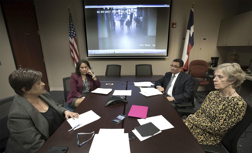 In this Thursday, Feb. 16, 2017 photo, El Paso County Attorney Jo Anne Bernal, from left, County Judge Veronica Escobar, District Attorney Jaime Esparza and Stephanie Karr, executive director of the Center Against Sexual and Family Violence, hold a teleconference in El Paso, Texas, with national and local media concerning Irvin Gonzalez, a transgender woman who was seeking protection from an abusive boyfriend, who was arrested by Immigration and Customs Enforcement agents. The video on the screen shows ICE officers holding Gonzalez's arm as they escort her from the El Paso County Courthouse. (Mark Lambie/The El Paso Times via AP)