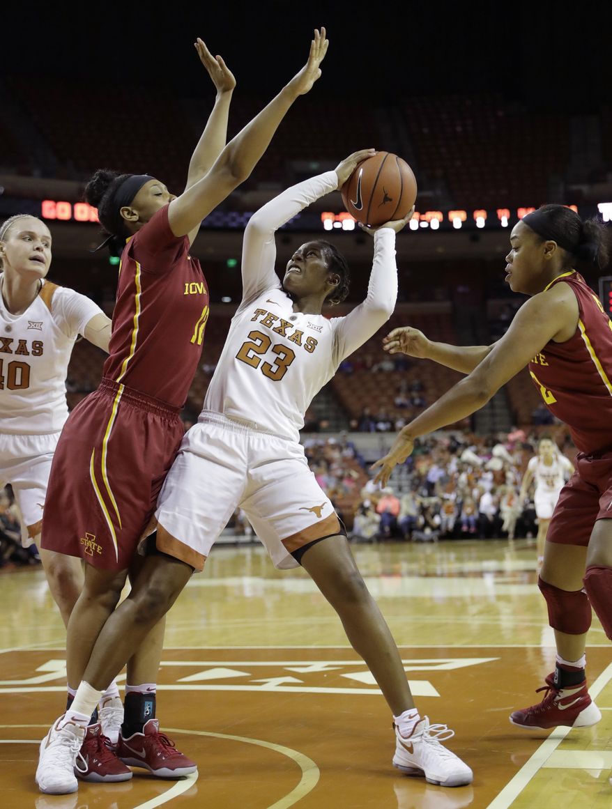 Texas guard Ariel Atkins (23) is pressured by Iowa State guard Seanna Johnson (12) as she looks to shoot during the first half of an NCAA college basketball game, Friday, Feb. 24, 2017, in Austin, Texas. (AP Photo/Eric Gay)