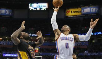 Oklahoma City Thunder guard Russell Westbrook (0) shoots in front of Los Angeles Lakers center Tarik Black during the second quarter of an NBA basketball game in Oklahoma City, Friday, Feb. 24, 2017. (AP Photo/Sue Ogrocki)