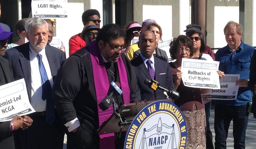 North Carolina's NAACP leader The Rev. William Barber speaks at a news conference on Friday, Feb. 24, 2017, in Raleigh, N.C., while the national NAACP president Cornell Brooks looks on. The two were announcing the first steps in a national economic boycott of the state over conservative policies including a law limiting LGBT rights. (AP Photo/Jonathan Drew)