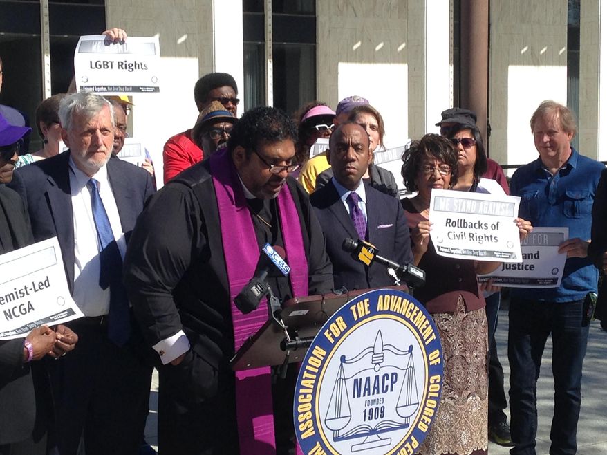 North Carolina's NAACP leader The Rev. William Barber speaks at a news conference on Friday, Feb. 24, 2017, in Raleigh, N.C., while the national NAACP president Cornell Brooks looks on. The two were announcing the first steps in a national economic boycott of the state over conservative policies including a law limiting LGBT rights. (AP Photo/Jonathan Drew)
