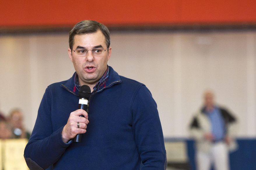 U.S Rep. Justin Amash, R-Cascade Township, speaks to the audience during a town hall meeting on Thursday, Feb. 23, 2017 at the Full Blast Recreation Center in Battle Creek, Mich. Amash is embracing the town halls that many of his Republican counterparts in Congress have avoided as people lash out at President Donald Trump’s early actions and the planned repeal of the federal health care law. (Carly Geraci/Kalamazoo Gazette-MLive Media Group via AP)