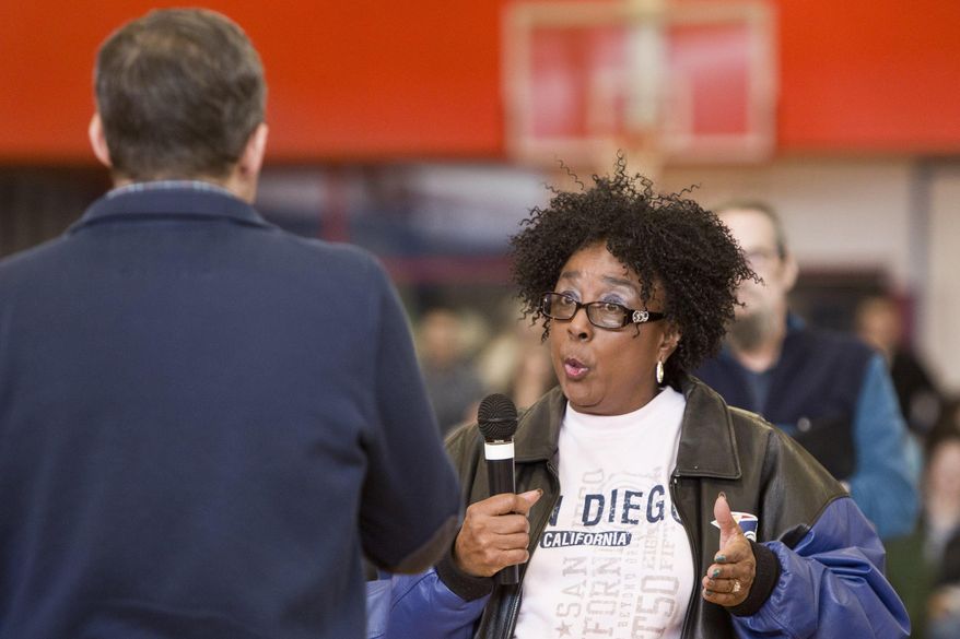 U.S Rep. Justin Amash, R-Cascade Township, left, speaks to a member of the audience during a town hall meeting on Thursday, Feb. 23, 2017 at the Full Blast Recreation Center in Battle Creek, Mich. Amash is embracing the town halls that many of his Republican counterparts in Congress have avoided as people lash out at President Donald Trump’s early actions and the planned repeal of the federal health care law. (Carly Geraci/Kalamazoo Gazette-MLive Media Group via AP)